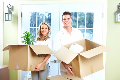Team planning a piano move inside a Finsbury Park flat with stairs and tight access